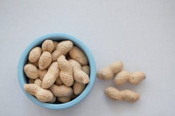 peanuts in the shell in a blue bowl