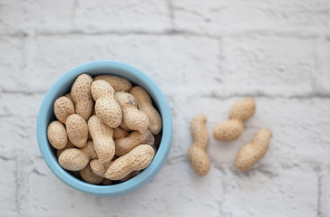peanuts in the shell in a blue bowl