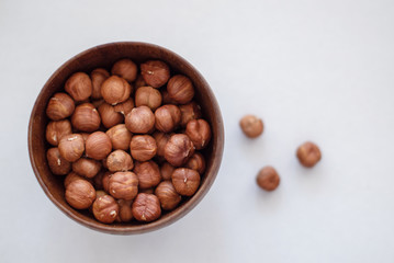 hazelnuts in a bowl on blue background