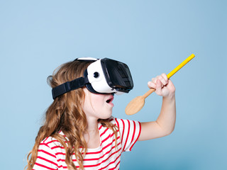 smiling positive girl wearing virtual reality glasses goggles headset is singing with cooking...
