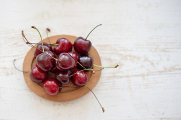 fresh ripe cherries on wooden background