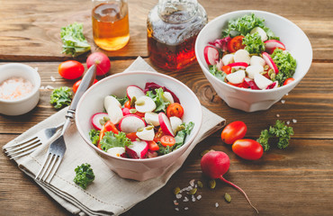 Salad with cherry tomatoes, radsh and mozzarella, lettuce mix