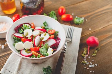 Salad with cherry tomatoes, radsh and mozzarella, lettuce mix