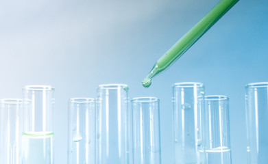 Pipettes take samples to a test tube containing chemicals.