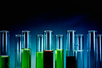 Multiple test tubes packed with chemicals, close-ups, background