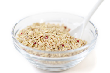 Muesli in a glass bowl on a white background