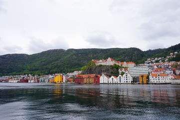 Color pallete fo houses next to the river with mountain in the background. Norway, Bergen