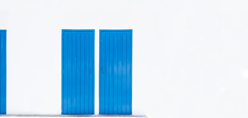 blue doors on white wall