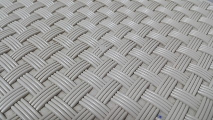 Closeup view of grey color plastic woven stripes.