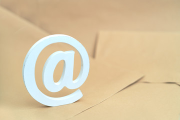 brown envelope with e-mail at sign on blue background
