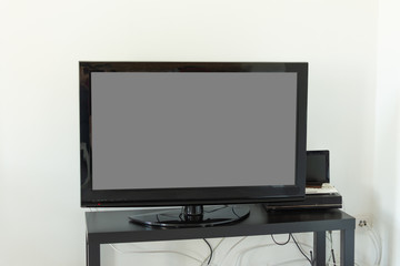Blank screen of TV set. Mockup for design. Modern flatscreen tv set indoor.