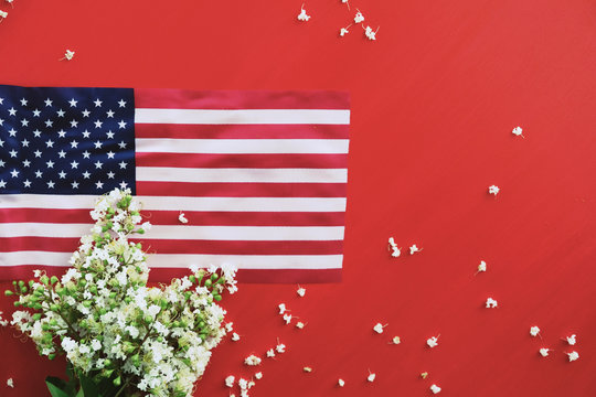 American Flag From United States On Red Background With Flowers And Copy Space.  Fourth Of July Or Memorial Day Holiday Banner.