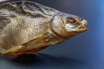 Head of dried bream on a black background. Fish dried bream. Beer Snack.