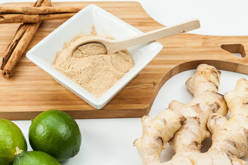 Ginger root with lemon and cinnamon photo on neutral background