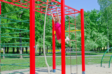 Obraz premium Little girl spends time on the playground