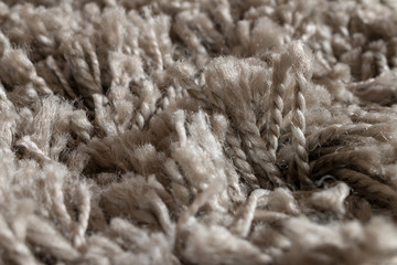 High pile rug. Braided threads. Twisted ropes. Gray carpet