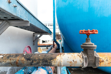 Rusty water pipe system and valve copy space for text.