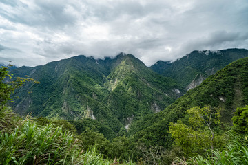 Fototapeta na wymiar Taroko Gorge National Park in Taiwan. Beautiful Green Hills Covered with Lush Foliage at Cloudy Overcast Weather