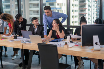 Group of young business people discussing in modern coworking space. Teamwork Cooperation . meeting .  communicating together. Working in the Office .Partnership . multiracial entrepreneurs