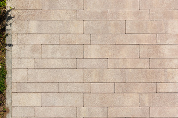 The surface is paved with road tiles of different sizes (multi format). The uneven color of the...