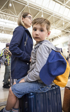 Tired Family At Airport While Waiting For Boarding