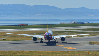 Passenger airplanes taxiing on runway
