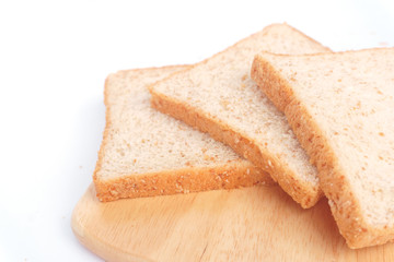 Close up brown sliced whole wheat bread isolated on white background.Healthy homemade sandwich breakfast preparing.Cooking bio ingredients.Food background concept with copy space.Top view.
