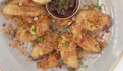 Fried Chicken Wings with Garlic and Pepper served with tomato sauce.