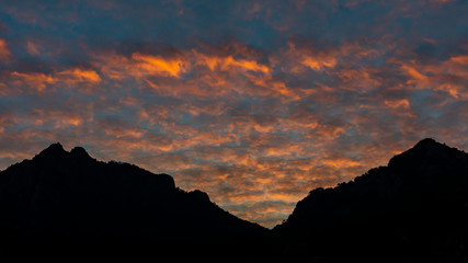 Colorful altocumulus clouds and sunset sky landscape on silhouette mountains. Marmaris, Turkey.