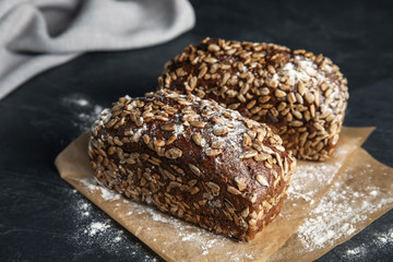 Fresh wholegrain bread on grey table, closeup