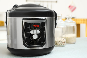New modern multi cooker on table in kitchen