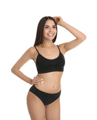 Fototapeta premium Portrait of attractive young woman with slim body in underwear on white background