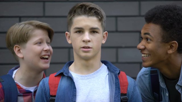 Student boldly looking into camera, resisting verbal bullying of classmates