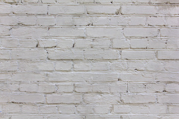 old shabby white brick wall with scratches. rough surface texture