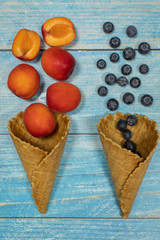 Berry and fruit ice cream. Blueberry, apricot in a waffle