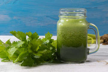 close up of fresh green celery juice on glass