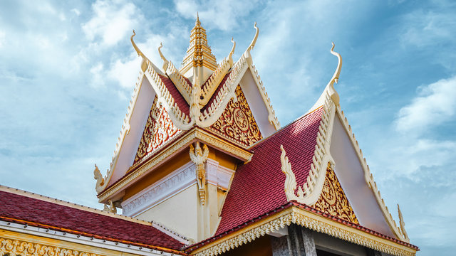 The topping part of the stunning Royal Palace (& Silver Pagoda) architecture with a beautiful clear blue sky, shot from low angle, located at the city of Phnom Penh, Cambodia.