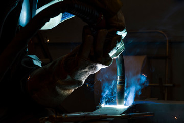 Industrial steel welder in factory welder, craftsman