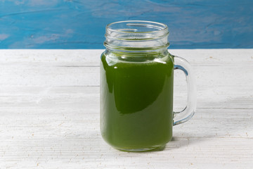 close up of fresh green celery juice on glass
