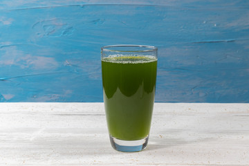 close up of fresh green celery juice on glass