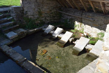 Planches de lavage où sont inscrits des mots comme bonheur, contemplation, santé,  dans ce lavoir où les lavandières venaient laver leur linge