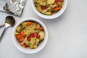 Vegetable stew of carrots, potatoes, cabbage and zucchini with hot peppers
