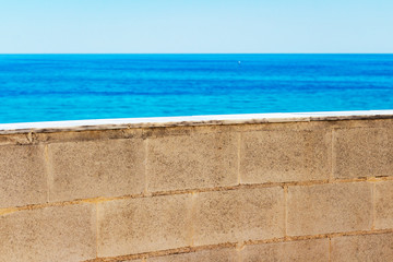 Fototapeta premium Blurred Mediterranean Sea view behind the Parque de la Bateria observation tower wall at Torremolinos, Province of Malaga, Andalusia, Spain