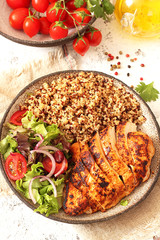 Healthy dinner.Grilled chicken and quinoa, mix salad and tomato 