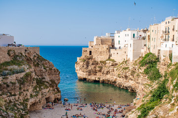 Panoramic city skyline with white houses and beach, town on the rocks, Puglia region, Italy, Europe. Traveling concept background with blue sea