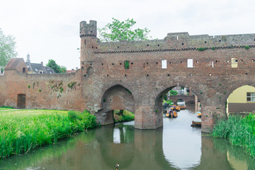 Fototapeta premium water gate with tower and city wall, called Berkelpoort in Zutphen, The Netherlands