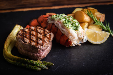 surf and turf on black stone plate