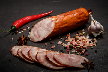 closeup smoked ham sausage with garlic and chili pepper