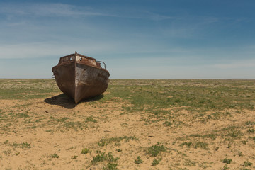 an old ship on land. at the bottom of the dried Aral sea