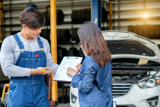 auto mechanic and female customer in garage